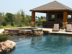 Free Form Pool and Spa with Patio Cover, Stamped Concrete and BBQ Island in Prosper