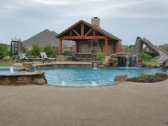 Free Form Pool with Grotto and Patio Cover with Fireplace in Lucas