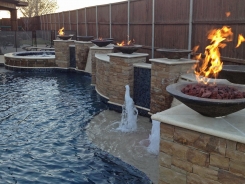 Free Form pool, Concrete Fire Bowls, Iridescent Glass Tile, Travertine and Stone Walls and Spa in Frisco (1)