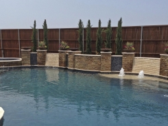 Free Form pool, Concrete Fire Bowls, Iridescent Glass Tile, Travertine and Stone Walls and Spa in Frisco (2)