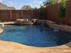 Iridescent Tile on Spa with Tiered Spillway and Raised Bond Beam with Water Features in Frisco