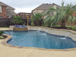 Iridescent Tile on Spa with Tiered Spillway and Raised Bond Beam with Water Features in Little Elm