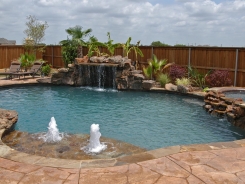 Stone Grotto and Tanning Ledge with Bubblers and Pebble Sheen in Prosper