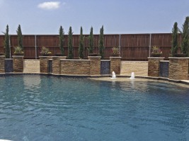 Free Form pool, Concrete Fire Bowls, Iridescent Glass Tile, Travertine and Stone Walls and Spa in Frisco