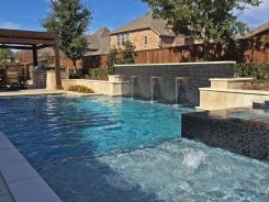 Geometric pool, Copper Water Bowls, Iridescent Glass Tile and Travertine Walls and Spa in Allen (1)