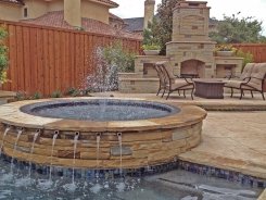 Iridescent Glass Tile Spa, Brass Spillways with Ocean Blue Pebble Sheen and Fireplace in Frisco