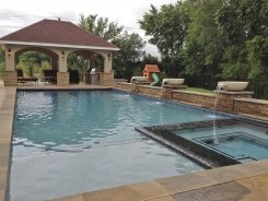 Iridescent Glass Tile Spa with Aqua Blue Pebble Sheen, Stucco Pavilion and Stone Water Bowls in Frisco