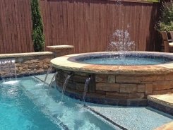 Iridescent Glass Tile Spa, Brass Spillways with Aqua Blue Pebble Sheen in Frisco