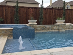 Iridescent Glass Tile Spa with Aqua Blue Pebble Sheen and Bubblers in Frisco