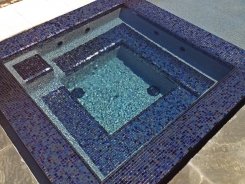 Iridescent Glass Tile Spa with Blue Granite Pebble Sheen in Frisco