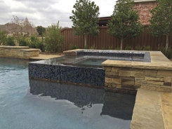 Iridescent Glass Tile Spa with Pebble Sheen in Frisco