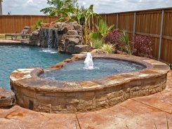 Raised Tile Spa with Pebble Sheen and Grotto in Prosper
