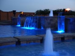 Geometric Pool with Blue Granite Pebble Sheen, LED Lighting and Copper Fire and Water Bowls in Frisco