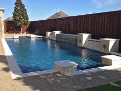 Geometric Pool with Travertine and Glass Tile Raised Bond Beam with mediterranean quartz in Allen