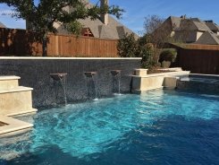 Geometric pool, Copper Water Bowls, Iridescent Glass Tile and Travertine Walls and Spa in Allen
