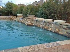 Geometric pool, Raised Bond Beam, Stone Water Bowls with Aqua Blue Pebble Sheen in Frisco (1)